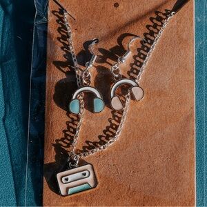 Headphone earrings and cassette necklace.